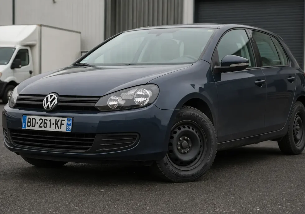 European Volkswagen car fitted with a durable commercial tire, parked in an industrial setting with reinforced tread visible.