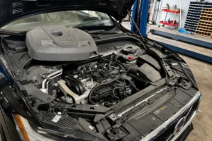Volvo repair Fort Lauderdale service center showing an open Volvo engine bay during professional engine diagnostics, maintenance inspection, and repair work in an automotive workshop.