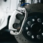 Close-up of a brake caliper and drilled rotor during brake repair at Southport Auto Repair in Fort Lauderdale